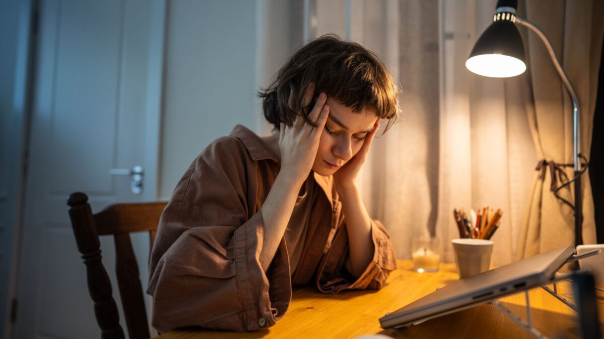 woman struggling to stay awake at her desk