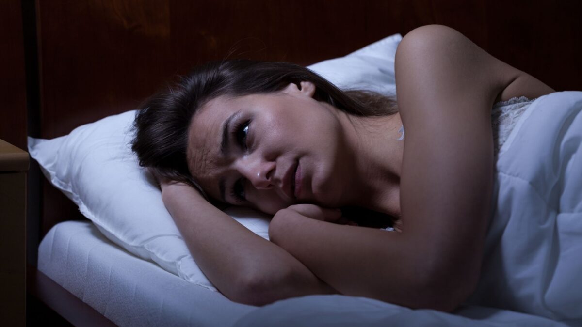 woman tired but can't sleep late at night