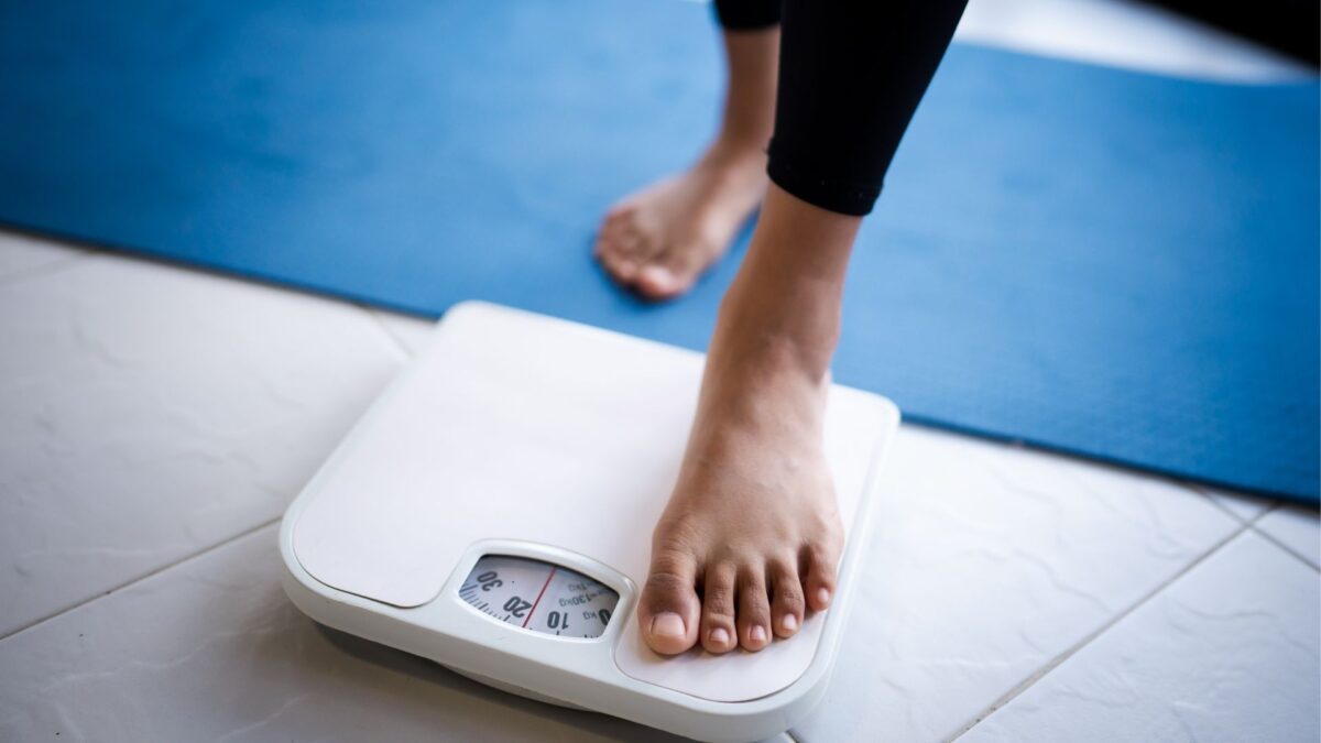 woman stepping on scales
